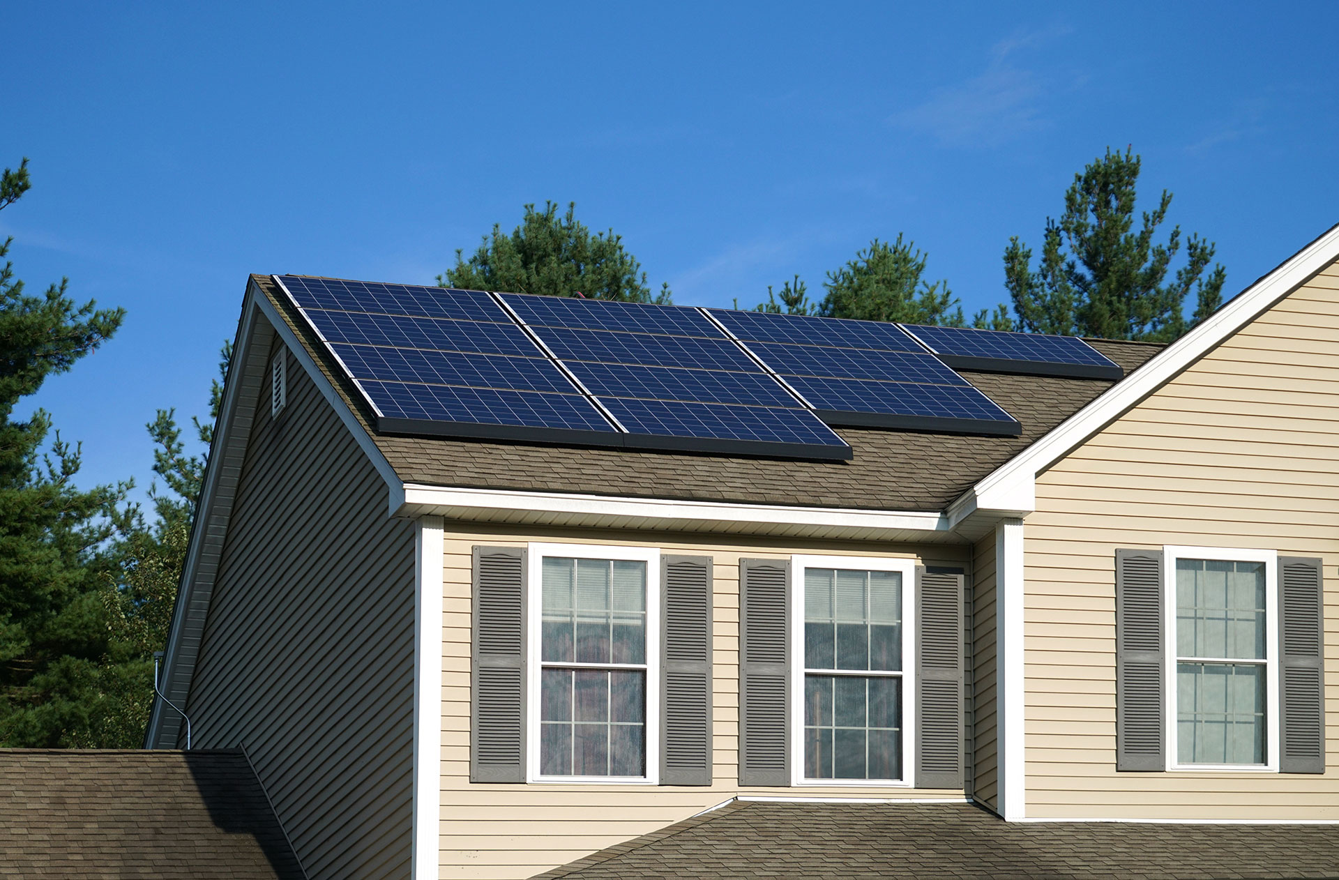 The upper portion of a home with newly installed solar panels on the roof